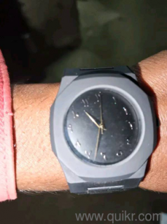 Aura" Branded Watch That Features a Matte Black Finish And a Dial With Arabic Numerals.