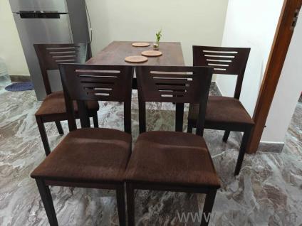 Well-Maintained 4-Seater Wooden Dining Table Set with Cushioned Chairs