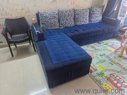 blue sofa cum bed with 4 pillows