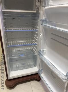 Haier Red colour 165 liters sparinly used fridge with stand in good and working condition is for sale