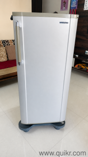 Samsung 183 L Direct Cool Single Door 5 Star Refrigerator (Gray Silver) with fridge stand.