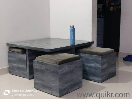 sturdy coffee table with 4 stools and cushions.
